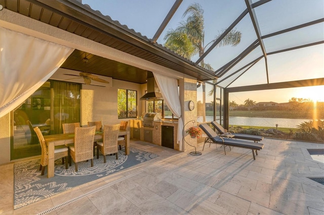 view of patio / terrace with a water view, area for grilling, ceiling fan, grilling area, and a lanai