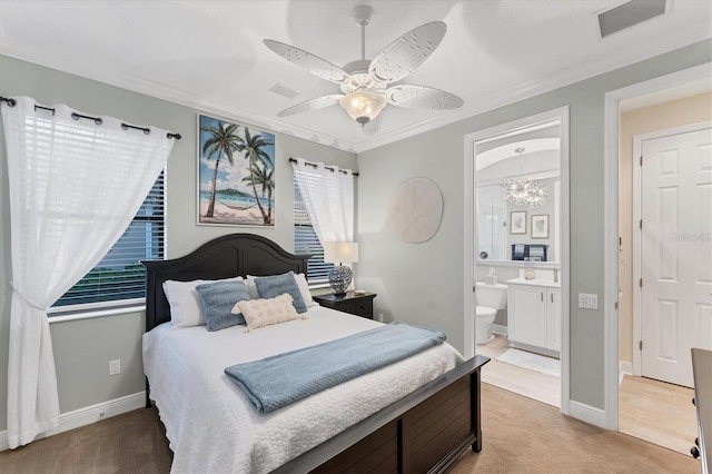 bedroom with visible vents, ornamental molding, a ceiling fan, ensuite bath, and light colored carpet