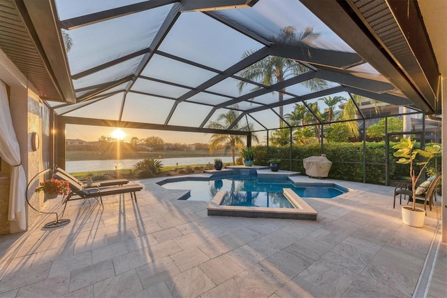 view of pool with glass enclosure, a patio area, a water view, and a pool with connected hot tub