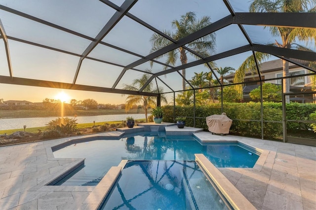 view of pool with a lanai, a patio area, and a pool with connected hot tub