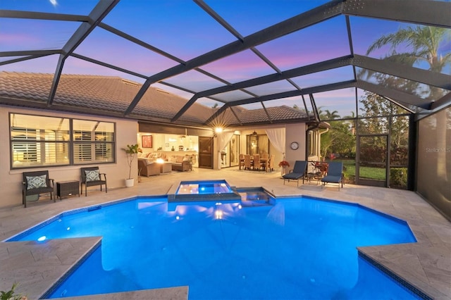 view of pool featuring a patio area, an outdoor hangout area, a pool with connected hot tub, and a lanai