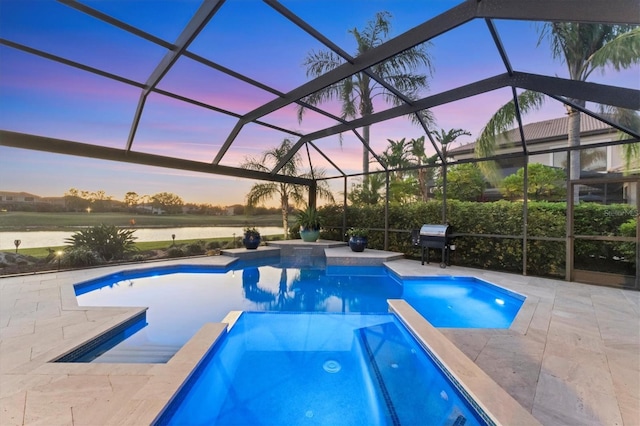 view of pool featuring glass enclosure, a pool with connected hot tub, and a patio