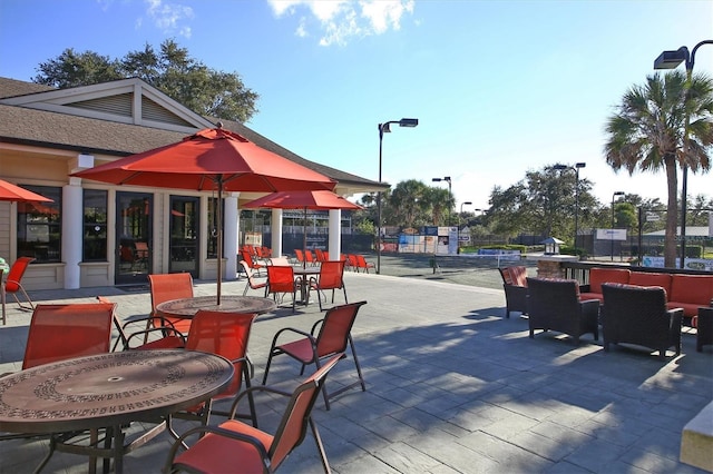 view of home's community featuring a patio and fence