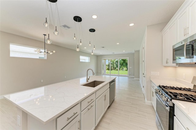 995 Waterline Ct, Sarasota, FL 34240 - kitchen with visible vents, white cabinets, appliances with stainless steel finishes, a sink, and recessed lighting