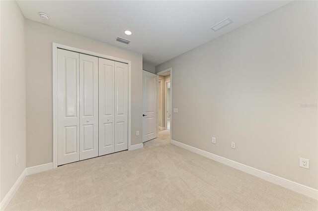 995 Waterline Ct, Sarasota, FL 34240 - unfurnished bedroom featuring light colored carpet, visible vents, and baseboards