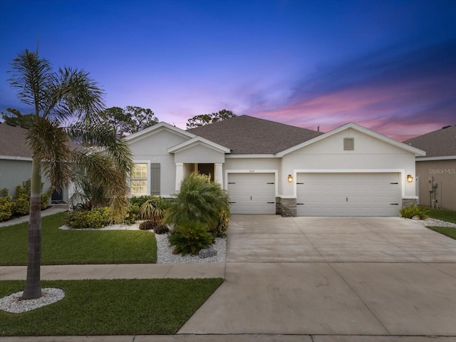 ranch-style house with stucco siding, a shingled roof, an attached garage, stone siding, and driveway