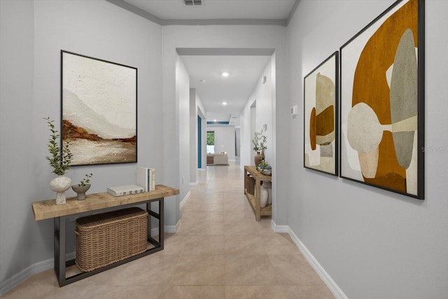 hallway with tile patterned flooring, visible vents, baseboards, and recessed lighting