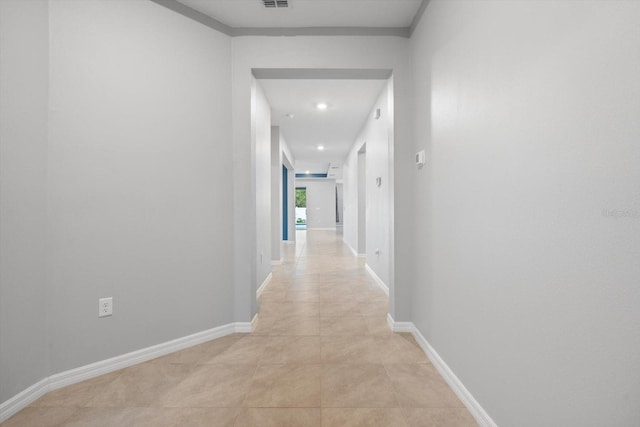 hallway featuring recessed lighting, visible vents, baseboards, and light tile patterned flooring