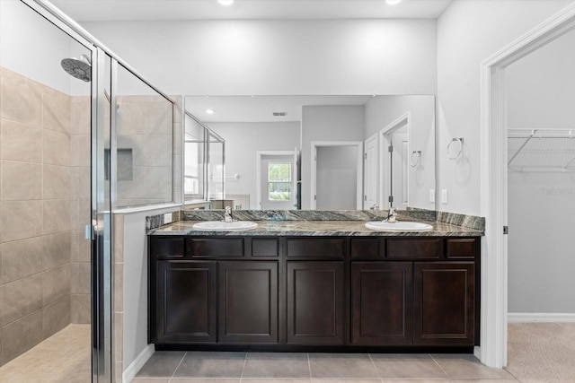 bathroom with a stall shower and a sink