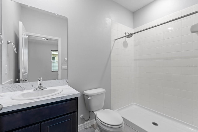 full bath featuring a stall shower, vanity, and toilet