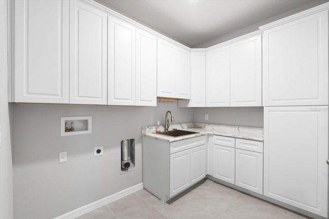 clothes washing area featuring light tile patterned floors, hookup for a washing machine, a sink, cabinet space, and electric dryer hookup