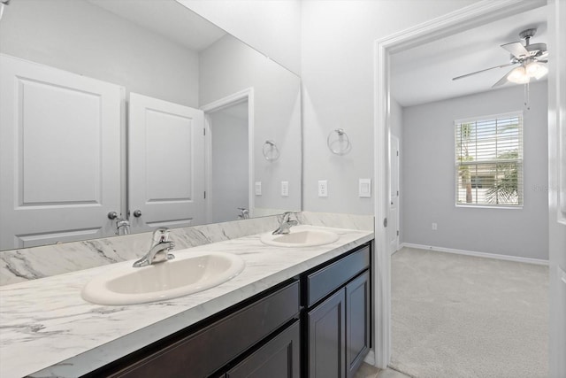 full bath featuring a ceiling fan, a sink, baseboards, and double vanity