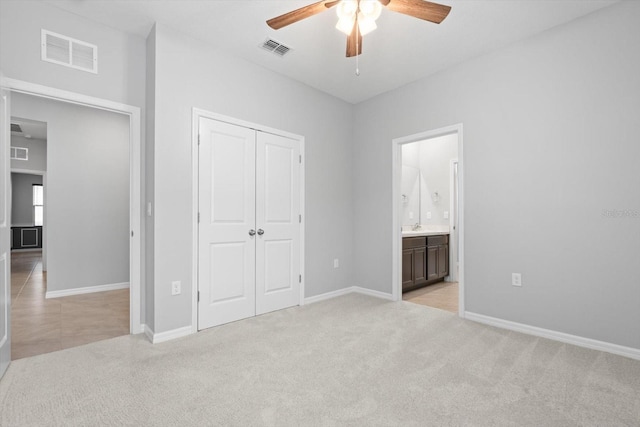 unfurnished bedroom with light carpet, a closet, visible vents, and baseboards