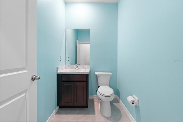 bathroom with vanity, tile patterned flooring, toilet, and baseboards