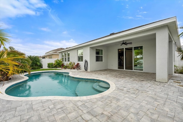 view of swimming pool featuring ceiling fan, fence, a fenced in pool, and a patio