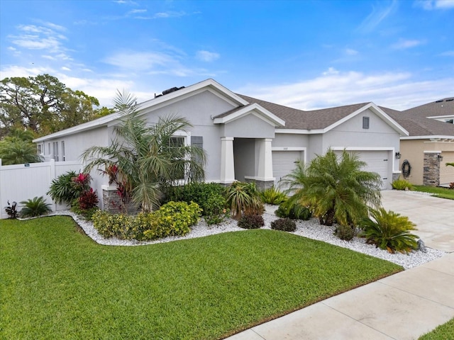 ranch-style house featuring stucco siding, a front yard, fence, a garage, and driveway