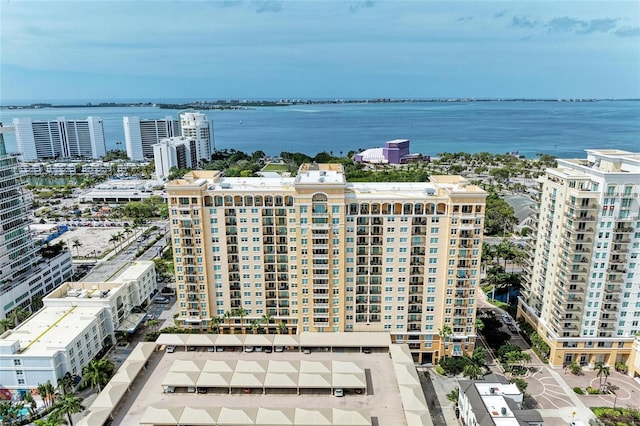 birds eye view of property with a water view and a view of city