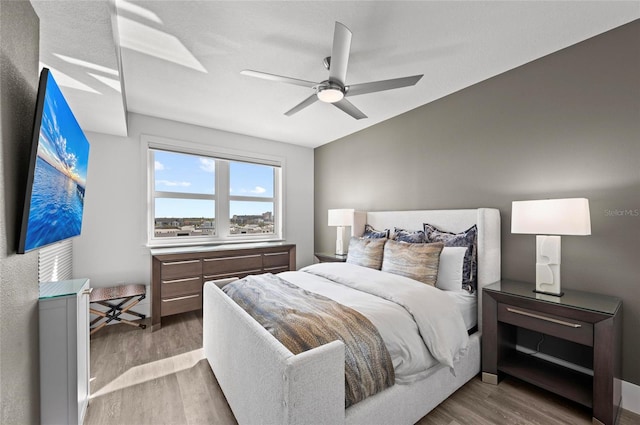 bedroom with ceiling fan and wood finished floors