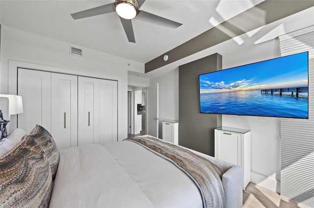 bedroom featuring a ceiling fan, a closet, and visible vents