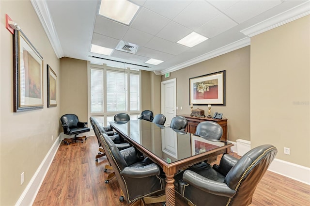 office featuring ornamental molding, visible vents, baseboards, and wood finished floors