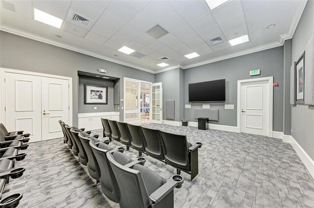 interior space with baseboards, visible vents, and ornamental molding