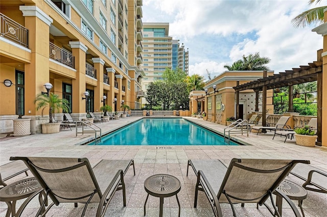 pool featuring a patio area and a pergola