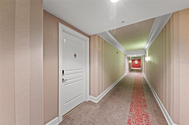 corridor featuring ornamental molding, baseboards, and wallpapered walls