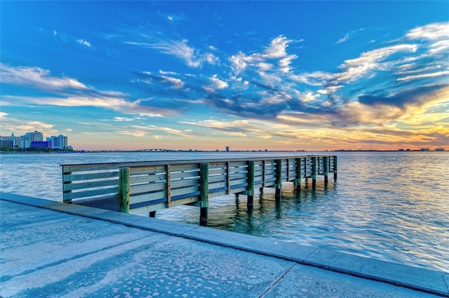 dock area featuring a water view and a city view