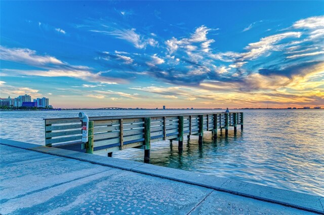 view of dock featuring a water view and a city view