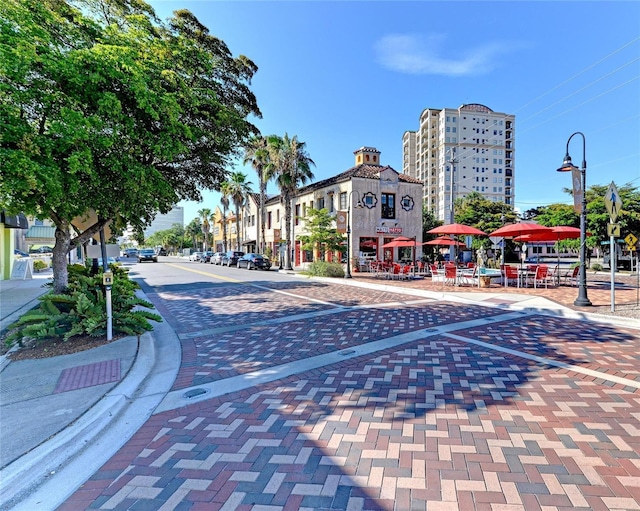 view of street featuring curbs, sidewalks, and street lights