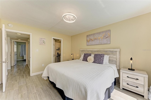 bedroom with light wood-type flooring and baseboards