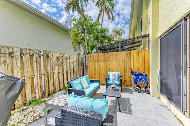 view of patio / terrace featuring fence, an outdoor living space, and grilling area