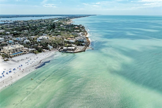 birds eye view of property with a water view and a view of the beach