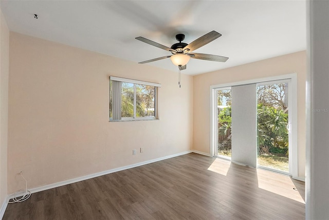 unfurnished room featuring wood finished floors, baseboards, and ceiling fan