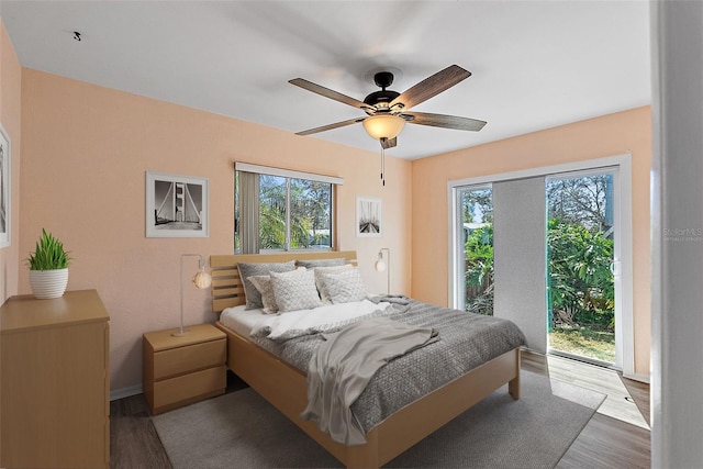 bedroom featuring wood finished floors, a ceiling fan, and access to outside