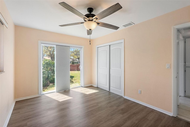 unfurnished bedroom with visible vents, baseboards, wood finished floors, a closet, and access to outside