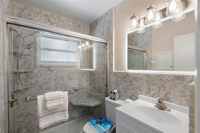 full bathroom featuring tasteful backsplash, toilet, vanity, a stall shower, and tile walls