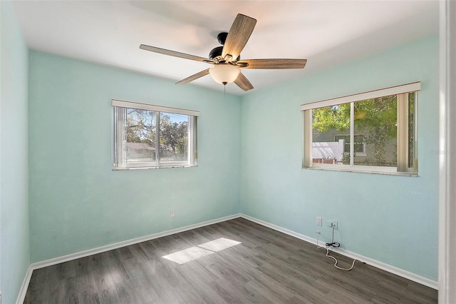 unfurnished room with a healthy amount of sunlight and baseboards