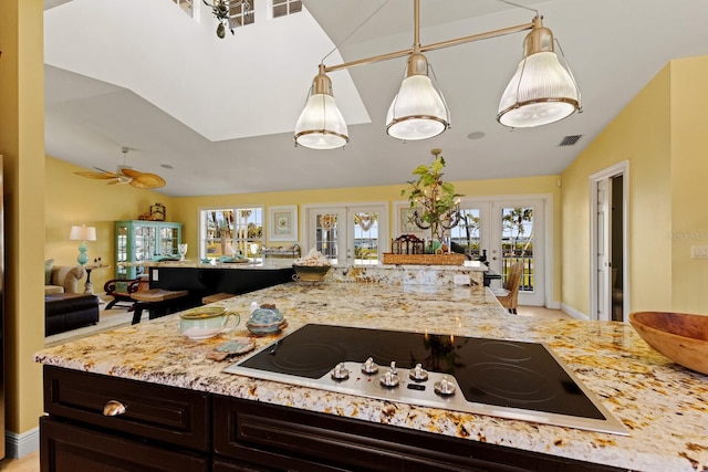 kitchen with visible vents, vaulted ceiling, light stone counters, electric cooktop, and french doors