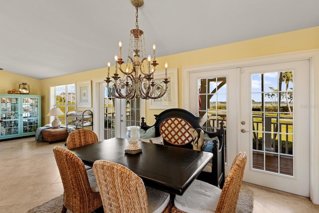 dining room with lofted ceiling, light tile patterned floors, french doors, and a wealth of natural light