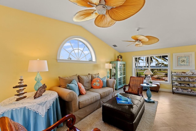 living room featuring tile patterned flooring, visible vents, baseboards, ceiling fan, and vaulted ceiling