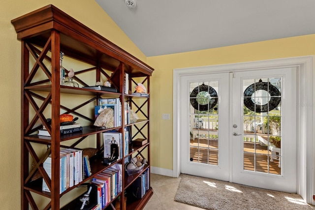 doorway to outside featuring lofted ceiling and french doors