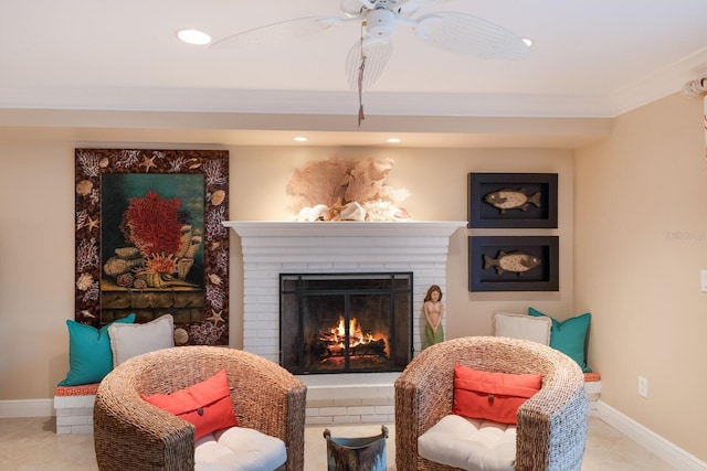 sitting room featuring baseboards, recessed lighting, ornamental molding, tile patterned floors, and a brick fireplace