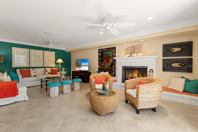 living area with recessed lighting, a ceiling fan, a brick fireplace, and crown molding