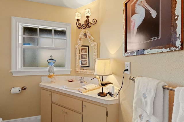 bathroom featuring baseboards and vanity