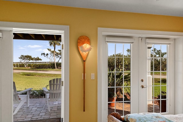 entryway with brick floor and french doors