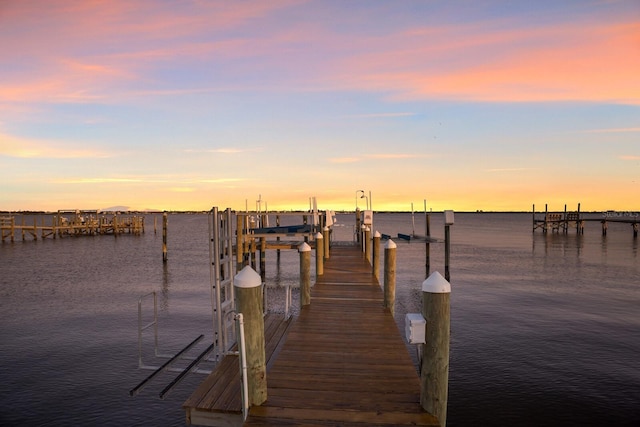 view of dock with boat lift and a water view