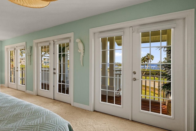 doorway to outside with french doors, carpet, and baseboards