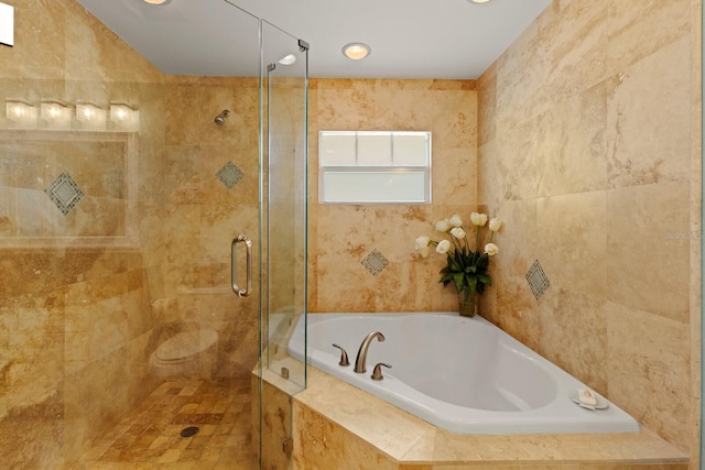 full bathroom featuring a garden tub and a stall shower