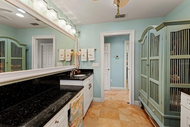 bathroom with visible vents, baseboards, and vanity